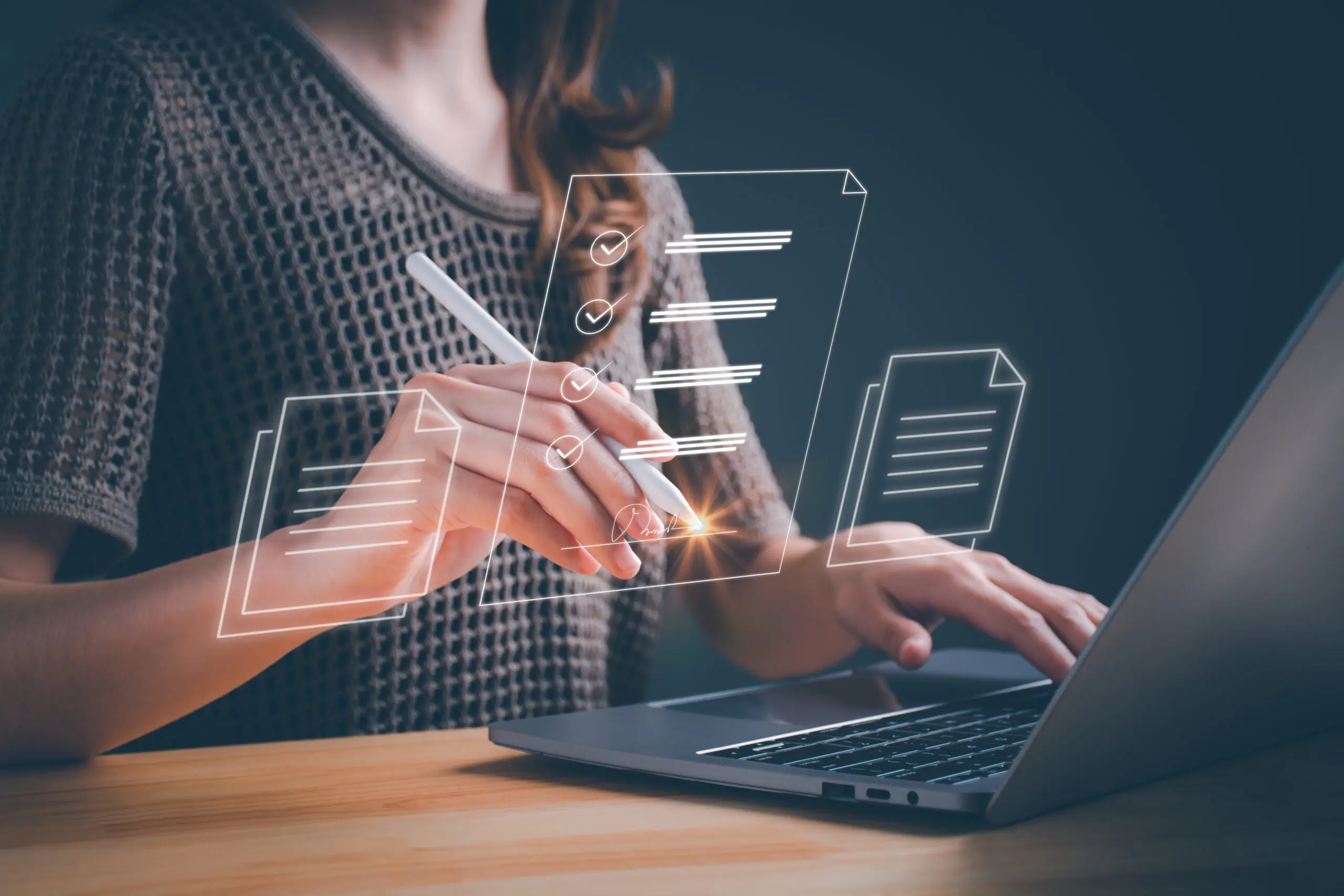 Person using laptop with digital checklist overlay.