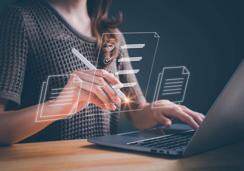 Person using laptop with digital checklist overlay.